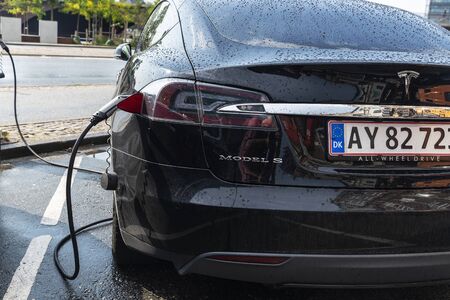 Copenhagen, Denmark - August 27, 2019: Tesla electric car Model S recharging batteries at a recharge...