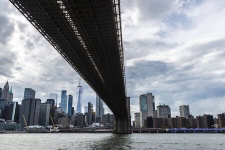 Skyline of the Brooklyn Bridge and modern skyscrapers of New York Financial District and the Lower...