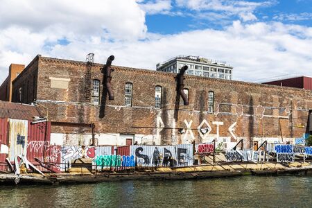 New York City, USA - August 2, 2018: Pier with old and abandoned industrial factories and warehouses in New York City, USAのeditorial素材