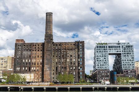 New York City, USA - August 2, 2018: Skyline of the Domino Park, an old factory and a modern building, from East River in Brooklyn, New York City, USAのeditorial素材