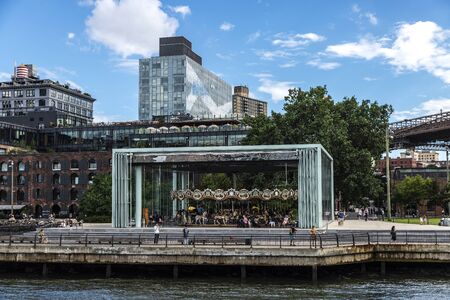 New York City, USA - August 2, 2018: Classic carousel on the East River with people around in Brooklyn, New York City, USAのeditorial素材