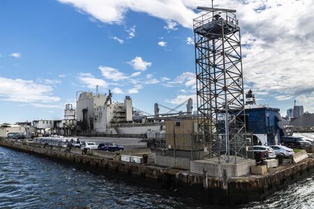 New York City, USA - August 2, 2018: Dock with industrial factories and warehouses on the East River in New York City, USAのeditorial素材