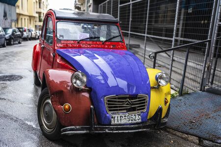 Athens, Greece - December 31, 2018: Red, yellow and blue Citroen 2CV (two steam horses or two tax horsepower) car parked on a street in Athens, Greeceのeditorial素材