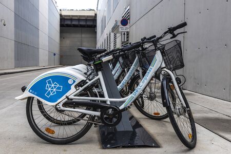 Athens, Greece - January 1, 2019: A row of rental bikes with advertising from SNFCC in their docking...
