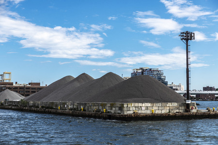Dock with industrial factories and warehouses of sand on the East River in New York City, USA