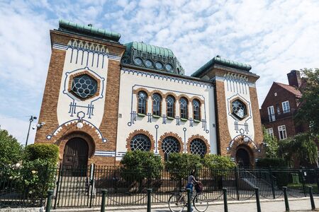 Malmo, Sweden - August 28, 2019: Facade of the Malmo Synagogue with a black girl in Malmo, Swedenのeditorial素材