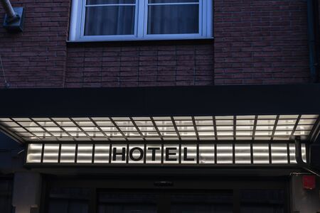 Hotel sign illuminated at night on a building in Malmo, Swedenの写真素材