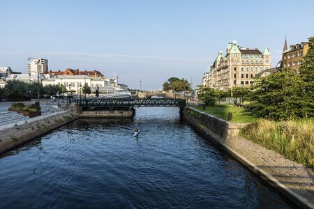 MalmÃ¶, Sweden - August 28, 2019: Man practicing canoeing in a canal in MalmÃ¶, Swedenのeditorial素材