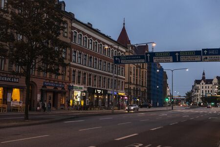Malmo, Sweden - August 28, 2019: Street with many shops, bars and restaurants with people around in MalmÃ¶; Swedenのeditorial素材