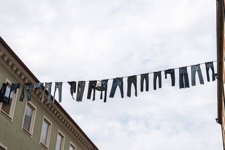 Trousers and clothes hanging in the middle of the street in MalmÃ¶, Swedenの写真素材