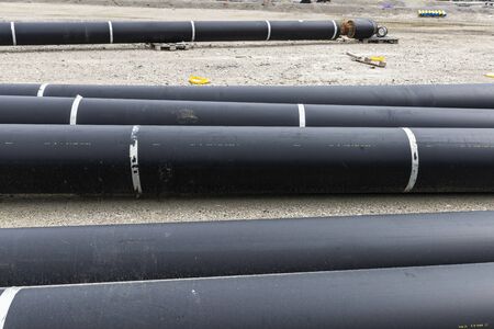 Large black pipes in a construction site in VÃ¤stra Hamnen, Malmo, Sweden 