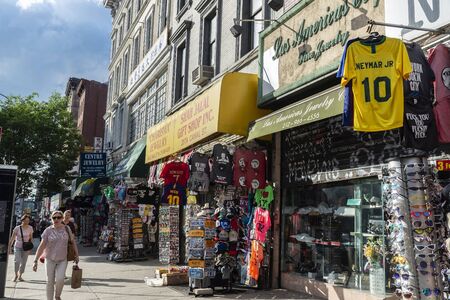 New York City, USA - August 2, 2018: Street with many shops and people around in Chinatown,...