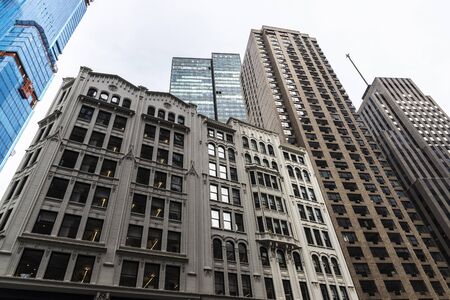 Low angle shot of modern skyscrapers and old classic buildings in Manhattan, New York City, USA