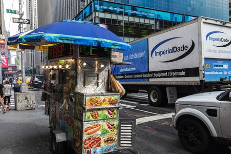 New York City, USA - August 3, 2018: Food truck with people around in 7th Avenue (Seventh Avenue),...