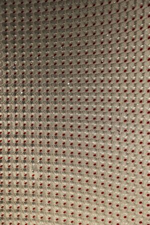 Carved glass ball wall with oval red glass pieces as abstract background