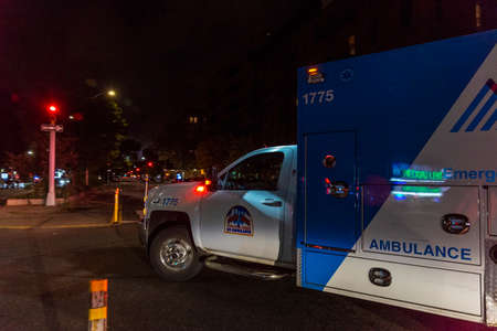 New York City, USA - August 4, 2018: Ambulance car of New York drive along on a street at night in Harlem, Manhattan, New York City, USAのeditorial素材