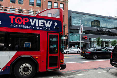 New York City, USA - August 4, 2018: Tour bus with people around drive along in Harlem, Manhattan, New York City, USAのeditorial素材