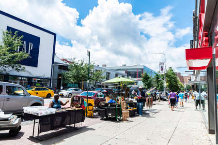 New York City, USA - August 4, 2018: Vendor in his clothes, jewelry and accessories stall on a street in Harlem, New York City, USAのeditorial素材