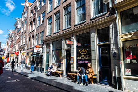 Amsterdam, Netherlands - September 7, 2018: Shopping street with bar and restaurants with people around in the old town of Amsterdam, Netherlandsのeditorial素材