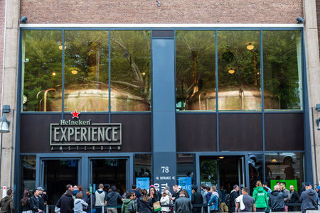 Amsterdam, Netherlands - September 8, 2018: Facade of Heineken brewery headquarters or Heineken Experience with people around in the centre of Amsterdam, Netherlandsのeditorial素材