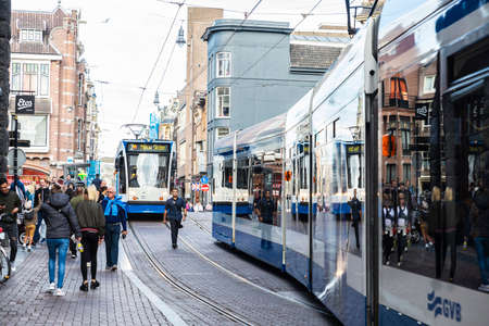 Amsterdam, Netherlands - September 9, 2018: Two trams circulating and people walking in Leidsestraat street,  Amsterdam, Netherlandsのeditorial素材