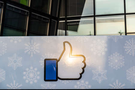 Dublin, Ireland - January 1, 2020: Logo of Facebook headquarters with a sunbeam, office building in...