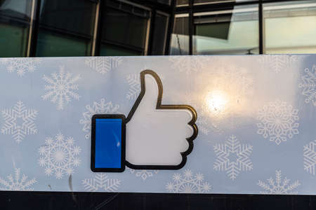 Dublin, Ireland - January 1, 2020: Logo of Facebook headquarters with a sunbeam, office building in Grand Canal Square, Dublin, Irelandのeditorial素材