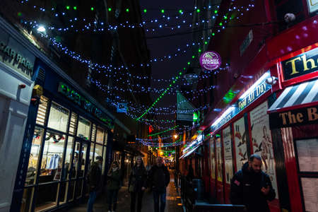 Dublin, Ireland - December 30, 2019: Shopping street with restaurants, shops with Christmas decoration and people around in the center of Dublin, Irelandのeditorial素材