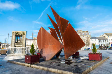 Galway, Ireland - January 3, 2020: Fountain depicting Galway Hookers in Eyre Square with Browne...