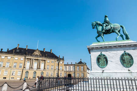 Copenhagen, Denmark - August 27, 2019: Equestrian statue of the King Frederick V and the facade of the Christian VIII Palace (Levetzau Palace) with people around in Amalienborg Square, Copenhagen, Denmarkのeditorial素材