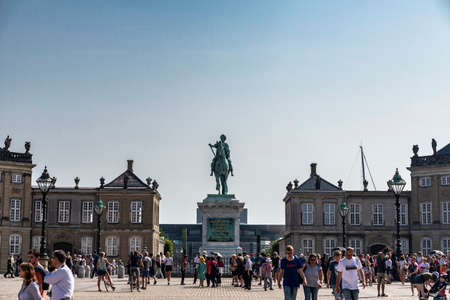Copenhagen, Denmark - August 27, 2019: Equestrian statue of the King Frederick V in the center of the Amalienborg Palace Square with people around in Copenhagen, Denmarkのeditorial素材
