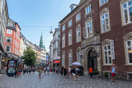 Copenhagen, Denmark - August 27, 2019: Facade of the MÃ¸inichen Mansion (MÃ¸inichen s PalÃ¦) in KÃ¸bmagergade, shopping street with people around in the center of Copenhagen, Denmarkのeditorial素材