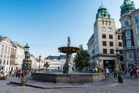 Copenhagen, Denmark - August 27, 2019: The Caritas Well (CaritasbrÃ¸nden), or the Caritas Fountain (Caritasspringvandet), is the oldest fountain in Copenhagen, located on Gammeltorv, part of the StrÃ¸get zone, with people around in Copenhagen, Denmarkのeditorial素材