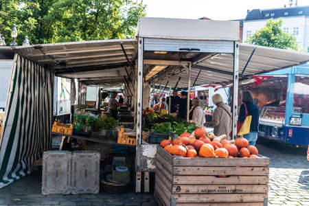 Hamburg, Germany - August 21, 2019: Vendor in a fruit and vegetable shop with people around in Farmer market GroÃneumarkt, street food market in Neustadt, Hamburg, Germanyのeditorial素材
