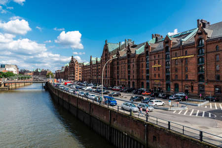 Hamburg, Germany - August 21, 2019: Classic buildings and Kehrwieder theater next to a canal in...