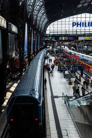 Hamburg, Germany - August 23, 2019: Interior of the Hamburg Hauptbahnhof, central railway station, with Philips advertising and people around in Hamburg, Germanyのeditorial素材