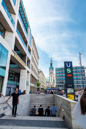 Hamburg, Germany - August 23, 2019: Facade of the Europa Passage, Hamburg luxury shopping arcade in Jungfernstieg, and an entrance of a subway station with people around in Hamburg, Germanyのeditorial素材