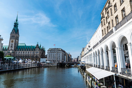 Hamburg, Germany - August 23, 2019: City hall and Alsterarkaden shopping arcade with luxury shops and restaurants in Jungfernstieg, an urban promenade in Neustadt, Hamburg, Germanyのeditorial素材