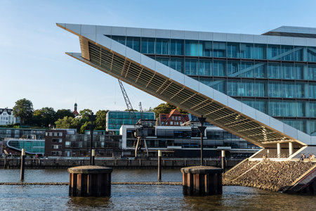 Hamburg, Germany - August 22, 2019: Dockland Office Building with people around on the Elbe river in...