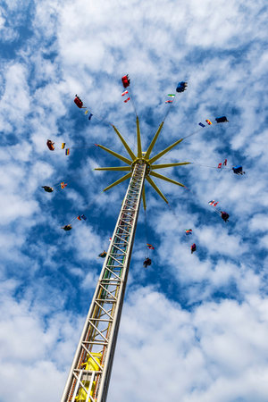 Hamburg, Germany - August 21, 2019: Attraction of the rotating pendulum with people around in the Hamburg DOM, amusement park on summer in Hamburg, Germanyのeditorial素材