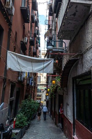 Naples, Italy - September 9, 2019: Narrow street in the Quartieri Spagnoli with a waiter waiting in the old town of Naples, Italyのeditorial素材