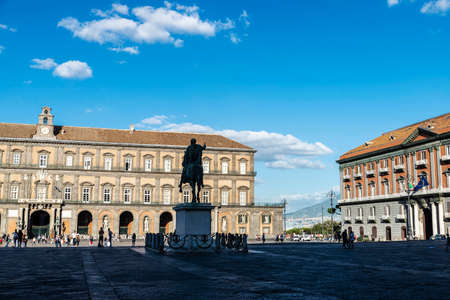 Naples, Italy - September 9, 2019: Facade of the Royal Palace of Naples (Palazzo Reale di Napoli) and the monument to Charles VII of Naples in Piazza del Plebiscito with people around, Italyのeditorial素材
