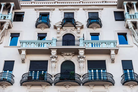 Facade of an old classic building with with semicircular balconies of wrought iron in the historical center of Naples, Italyのeditorial素材