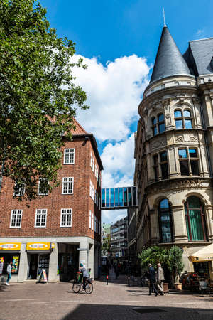 Bremen, Germany - August 19, 2019: Narrow street with a terrace of bar and people around in Bremen, Germanyのeditorial素材