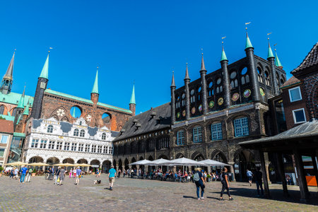 LÃ¼beck, Germany - August 24, 2019: LÃ¼beck Town Hall with a terrace bar and people around on Market Square in LÃ¼beck, Germanyのeditorial素材