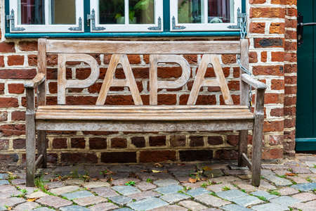 Wooden bench with the word Papa in the old town of Lunenburg, Lower Saxony, Germanyの写真素材