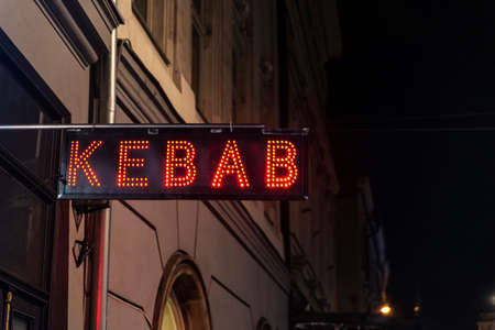 Illuminated red sign of a kebab at night in Krakow, Polandの写真素材