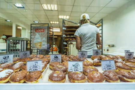 Krakow, Poland - August 28, 2018: Vendor with an assortment of traditional Paczki in a pastry shop in the historical center of Krakow, Polandのeditorial素材