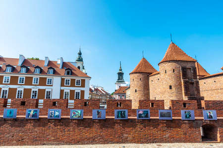 Warsaw, Poland - September 1, 2018: Warsaw Barbican or Barbakan Warszawski with an exhibition of works of art in the old town of Warsaw, Polandのeditorial素材