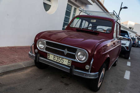 Fornells, Spain - July 20, 2021: Garnet Renault 4 Super car with roof rack parked on a street in...
